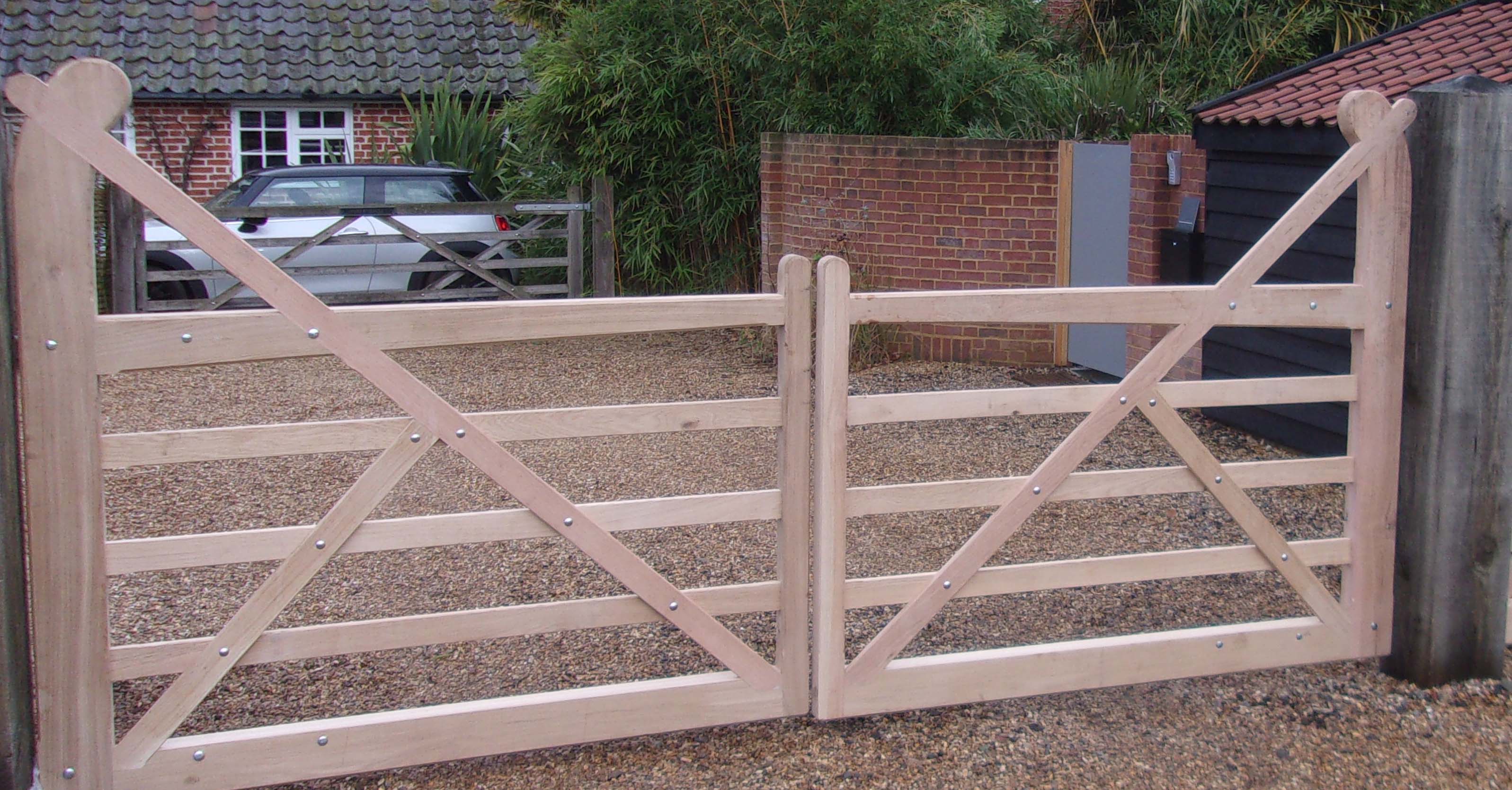 Equal pair of Oak Butley gates with solid base rails