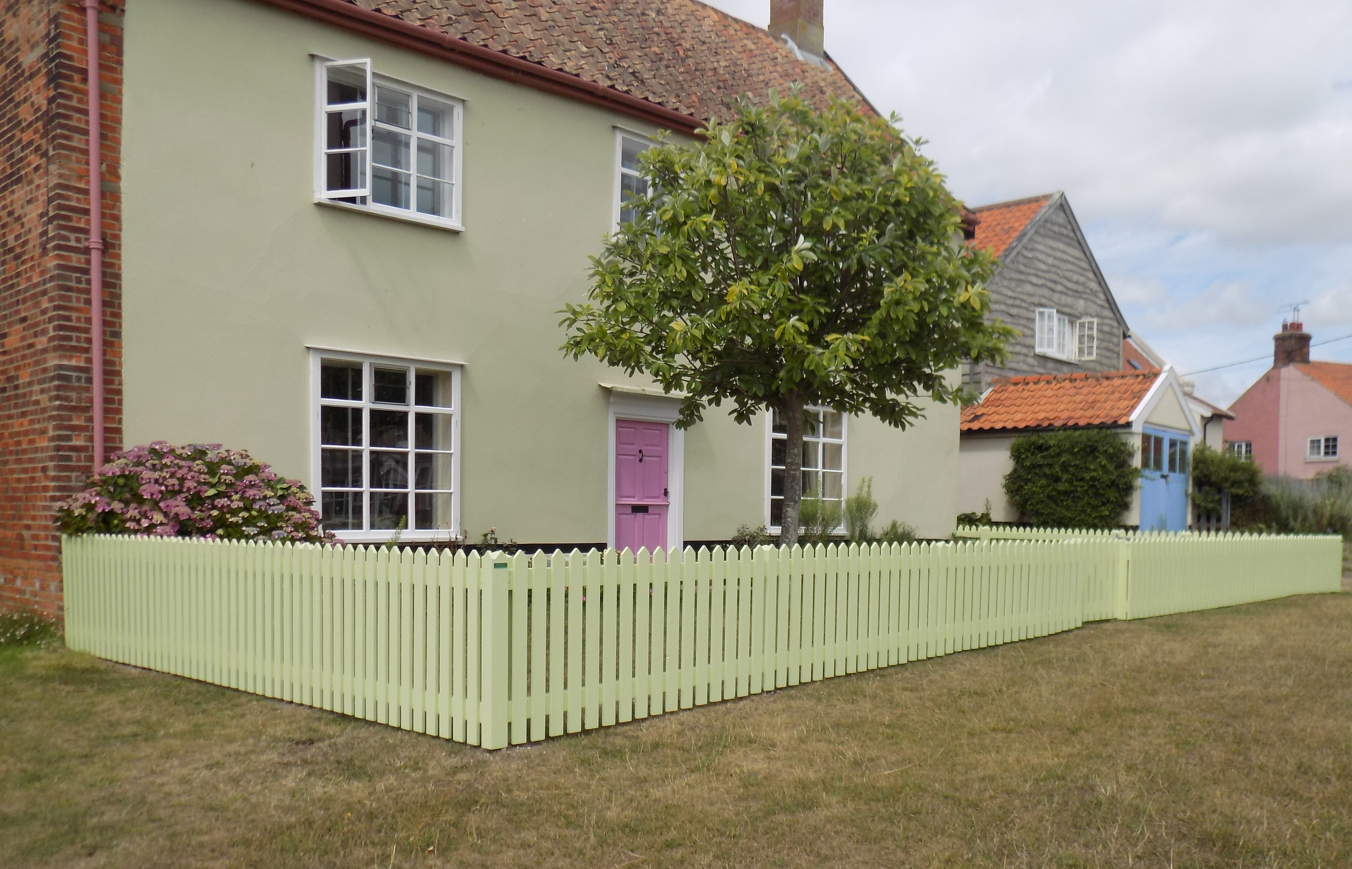 Picket fencing with pointed top finished in Cuprinol shades fresh pea